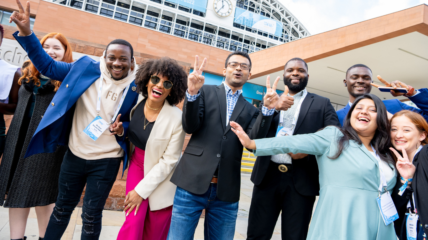 Delegates smiling at the One Young World Summit Manchester 2022 