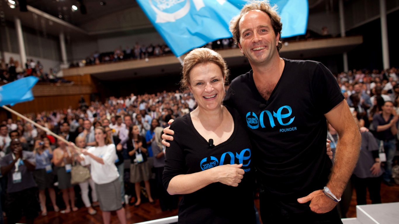 Co-Founder of One Young World Kate Robertson and David Jones smiling on stage at the One Young World Summit Zurich 2011