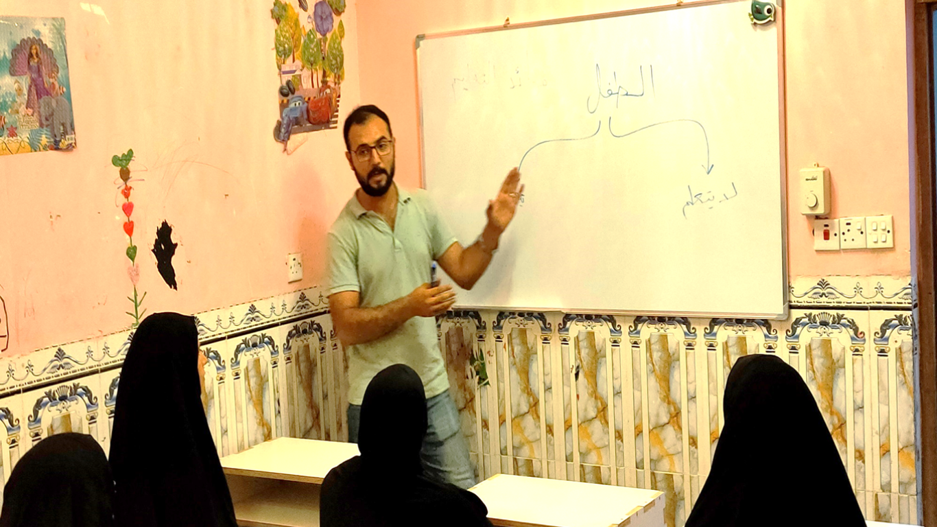 Image of Hasan Azeez teaching a group of students