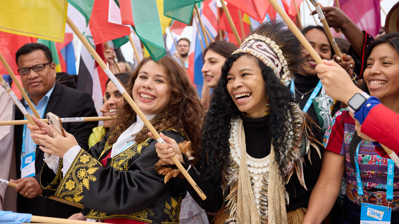 Flag bearers at the One Young World Summit Belfast 2023 smiling