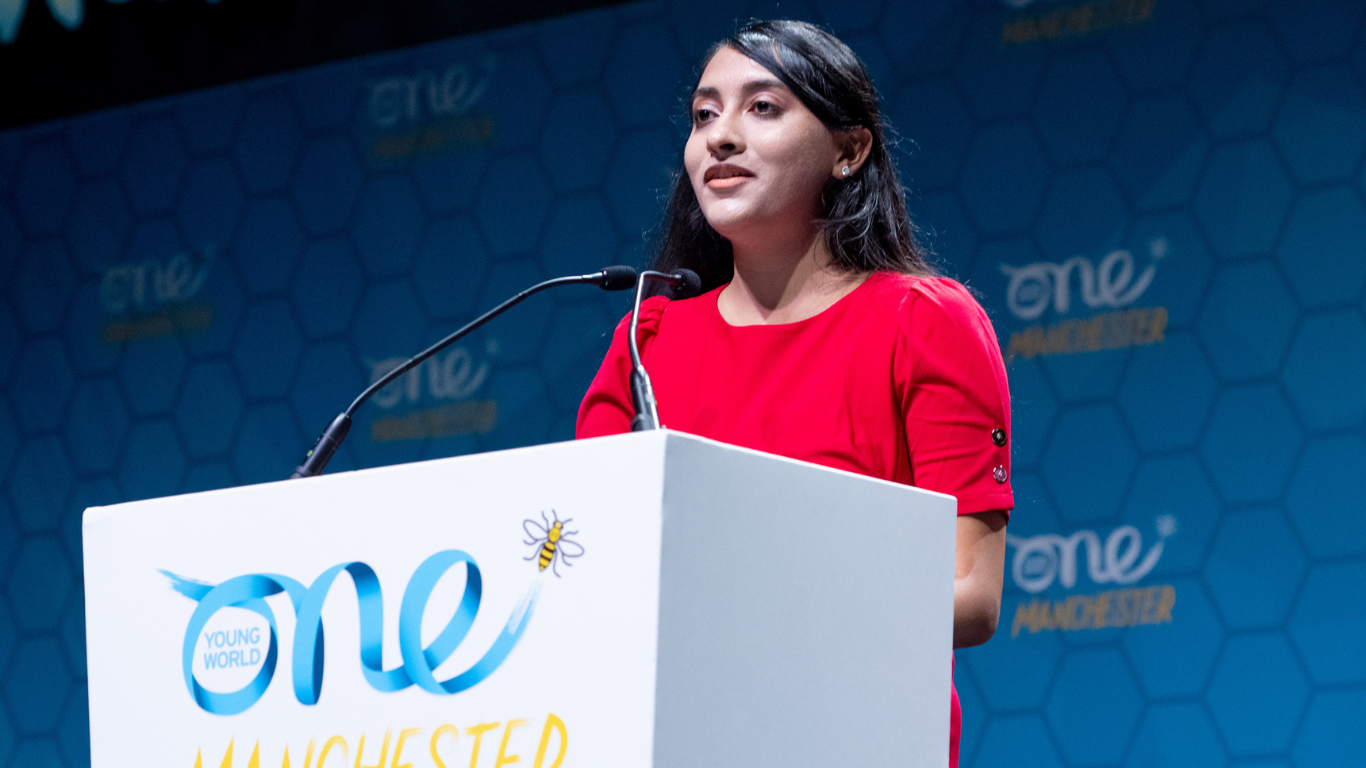 Swara Patel talking on stage at the One Young World Summit Manchester, 2022