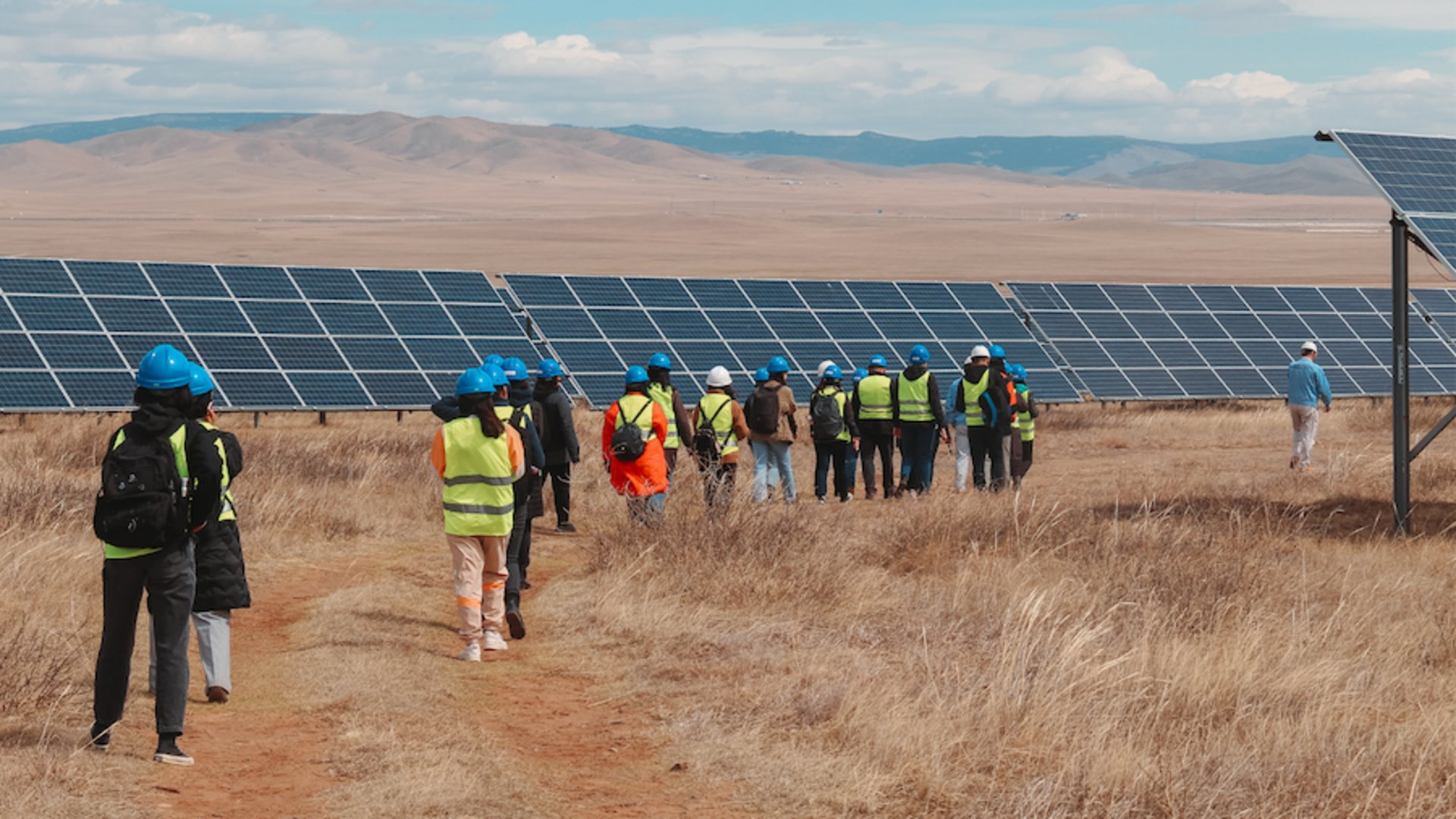 A group of visitors to a solar energy installation built by a One Young World Ambassador's initiative