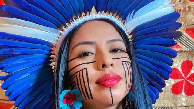 Maricelma Francelino Fialho Cândido wearing Indigenous headwear and face paint